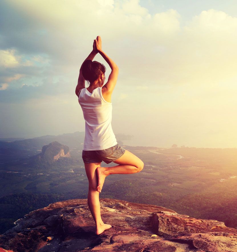 Person doing Yoga on a mountaintop Person doing Yoga on a mountaintop